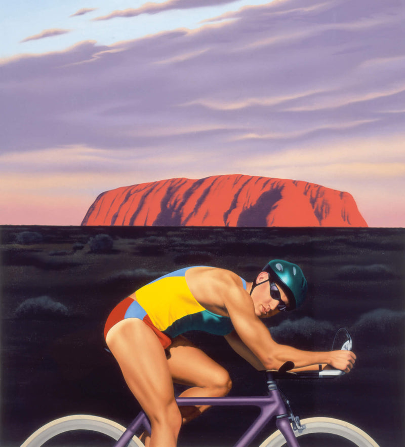 Male Cylist in front of Uluru